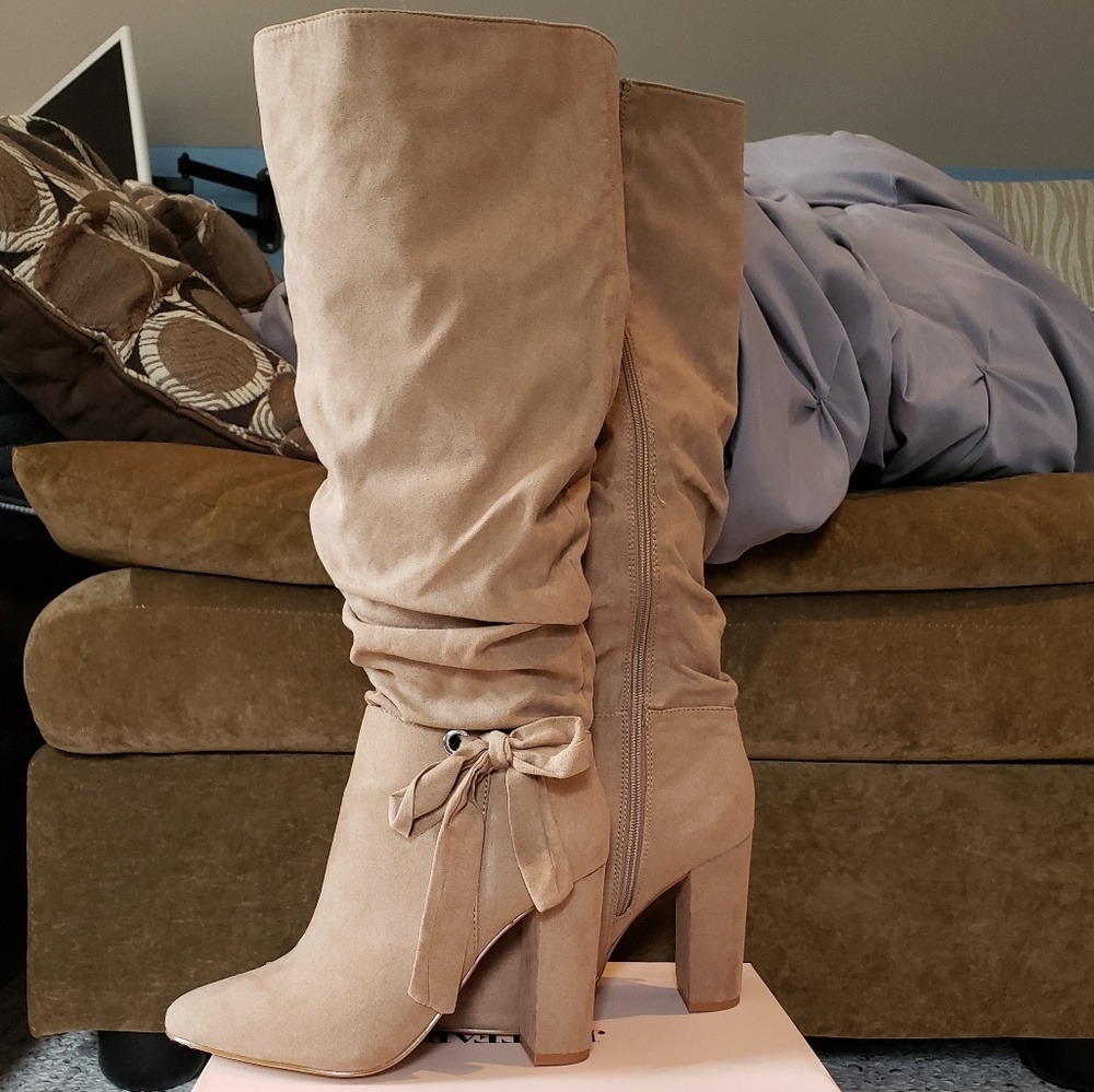 Knee high heeled boots, never worn.